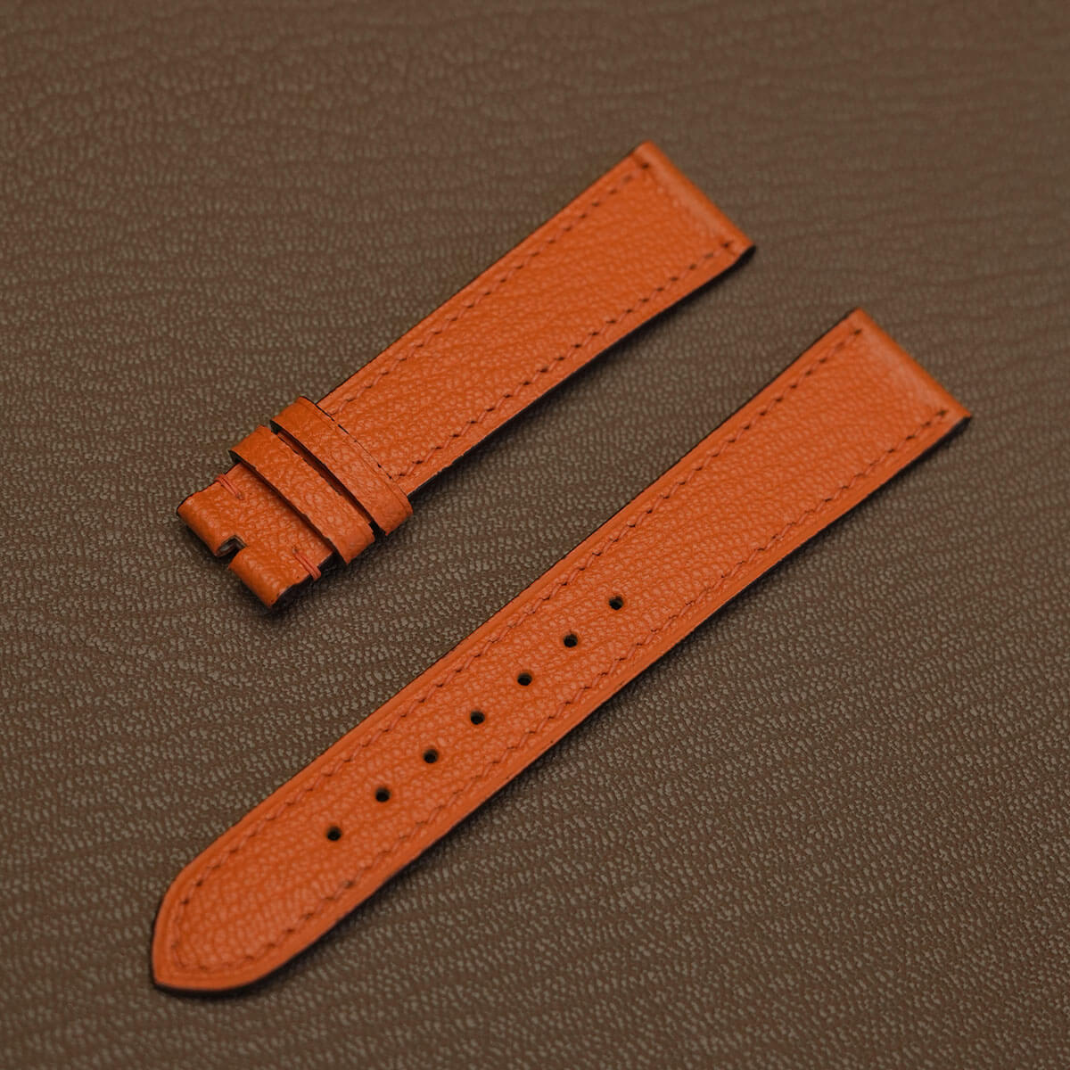 Pair of tailored French Alran goat leather watch bands in orange showing 115mm by 75mm flat profile