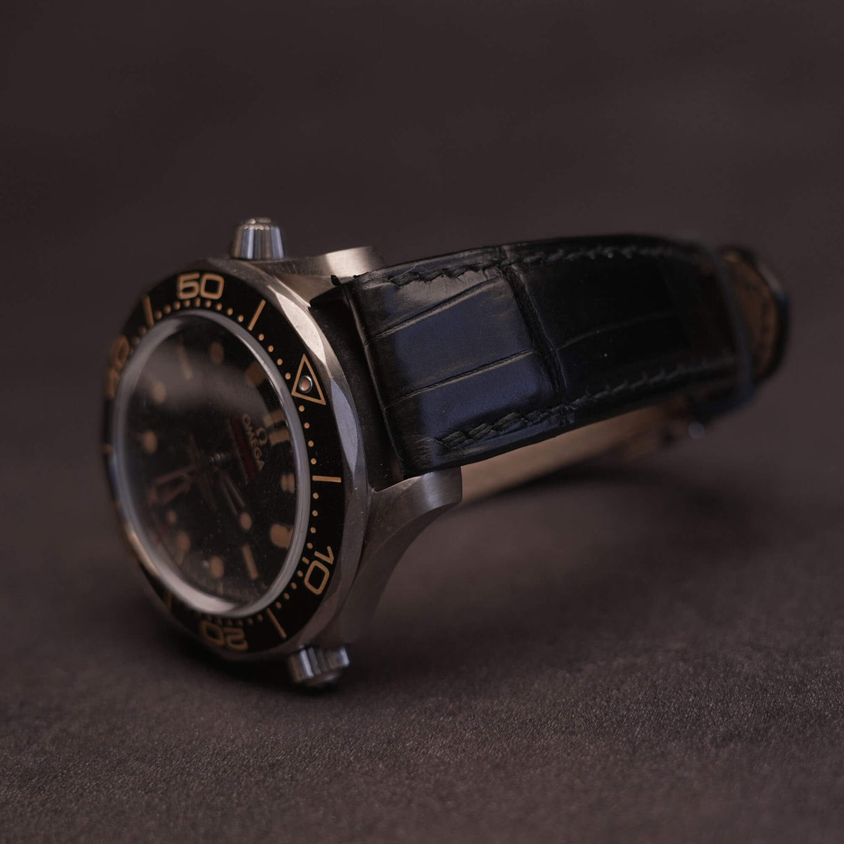 Front view of a premium black French HCP crocodile leather watch strap with elegant bamboo scale pattern and traditional hand-stitched saddle stitching.