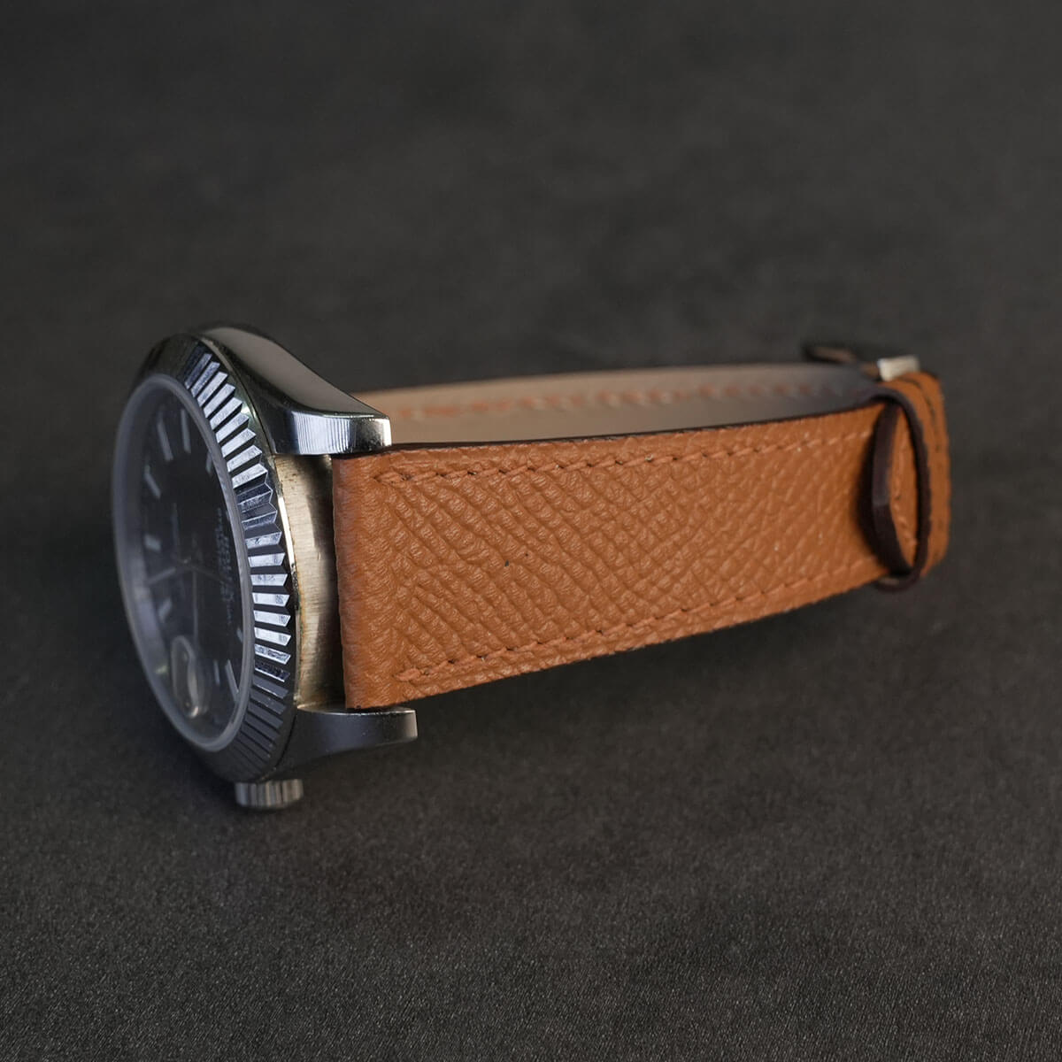 Light brown French Epsom calfskin watch strap fitted on steel luxury watch case side view