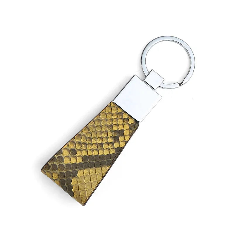 Keychain with yellow snake skin on a white background