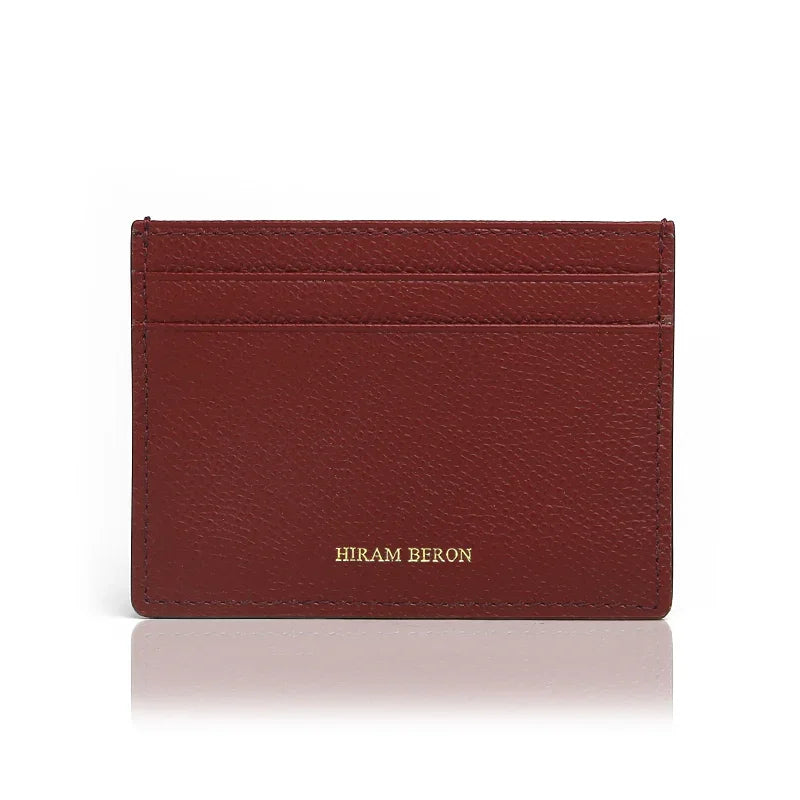 burgundy leather cardholder with 'Hiram Beron' branding on a white background