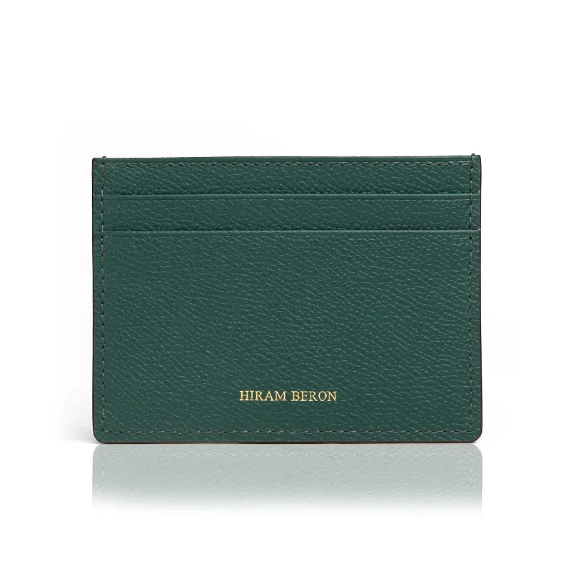 Green leather cardholder with 'Hiram Beron' branding on a white background