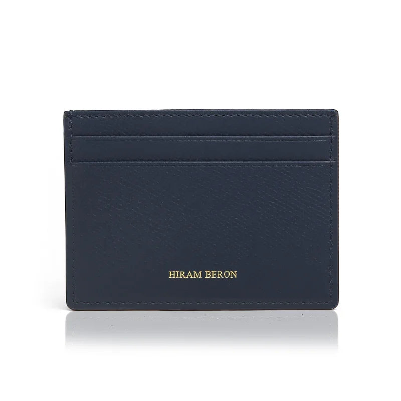 Navy leather cardholder with 'Hiram Beron' branding on a white background