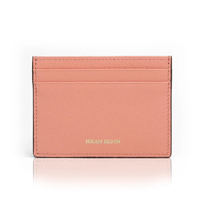 Pink cardholder with 'Hiram Beron' branding on a white background