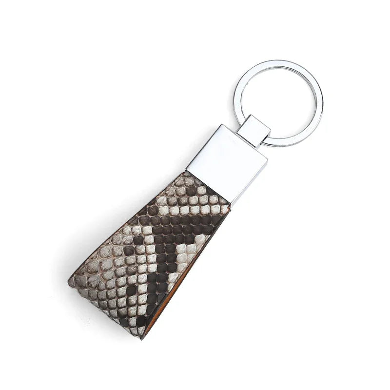 Keychain with natural snake skin on a white background