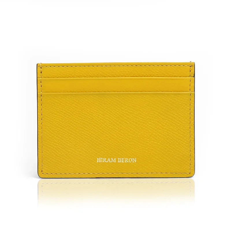 Yellow cardholder with 'Hiram Beron' branding on a white background