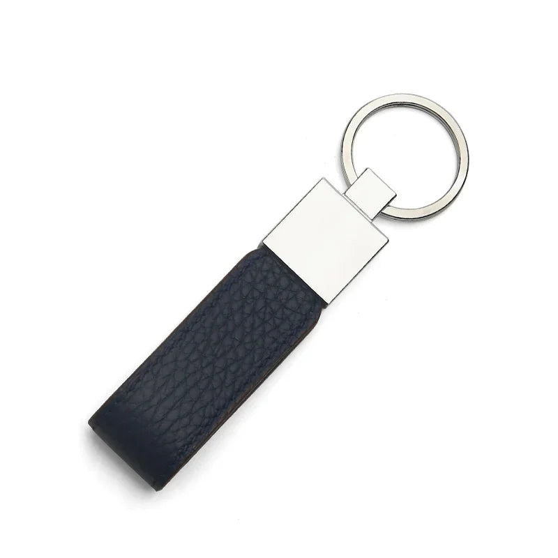 navy blue leather key fob with silver metal tag on a white background