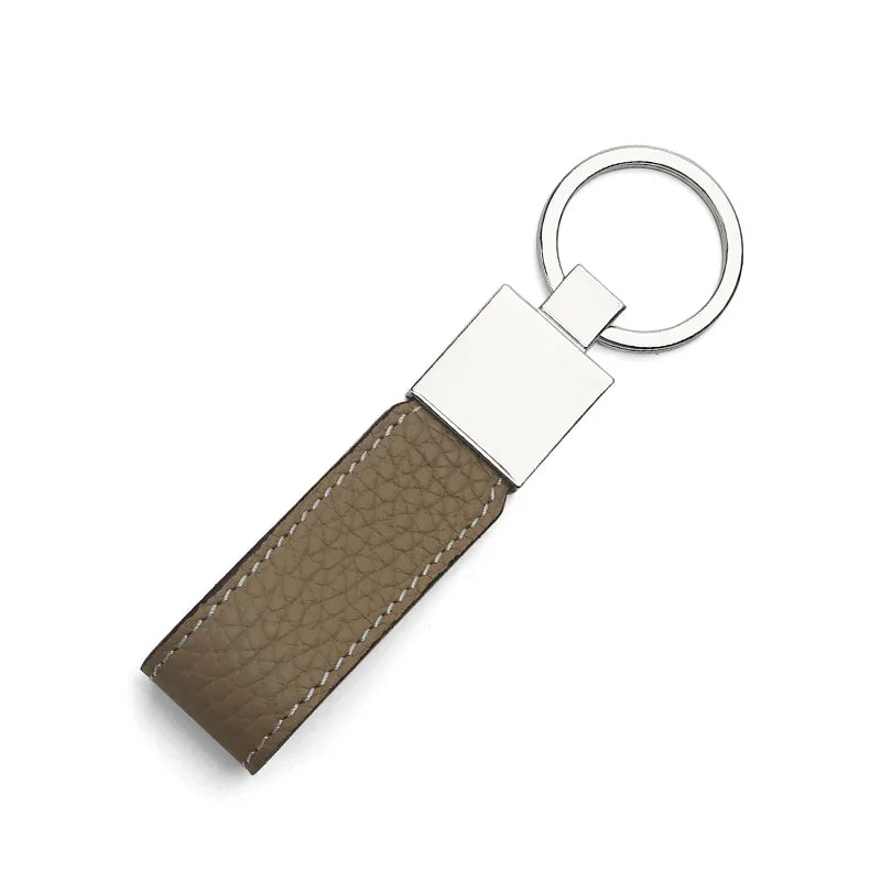 Apricot leather keychain with a silver metal tag on a white background