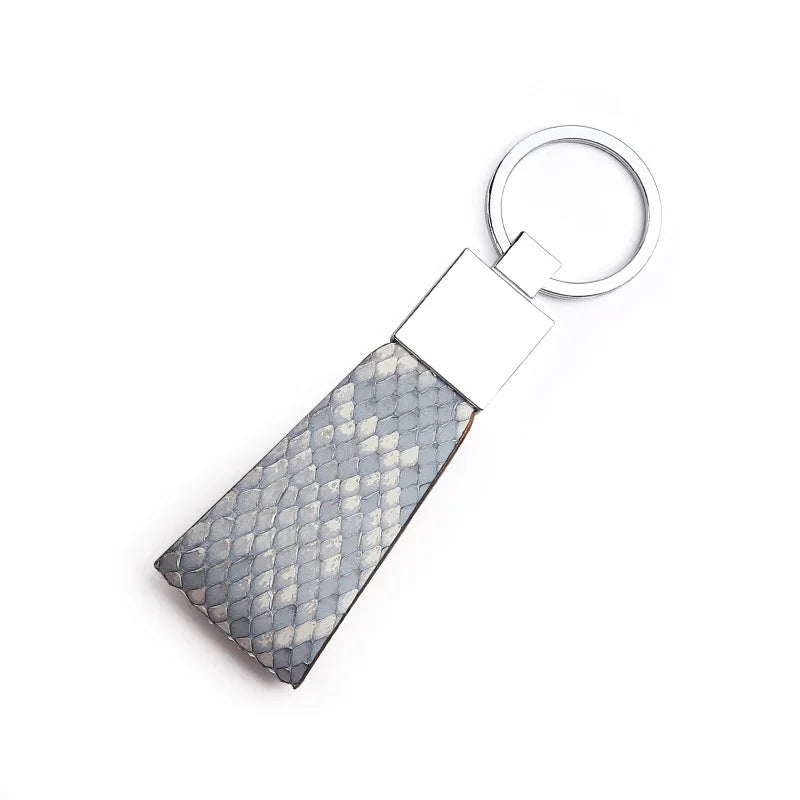 Keychain with grey snake skin on a white background