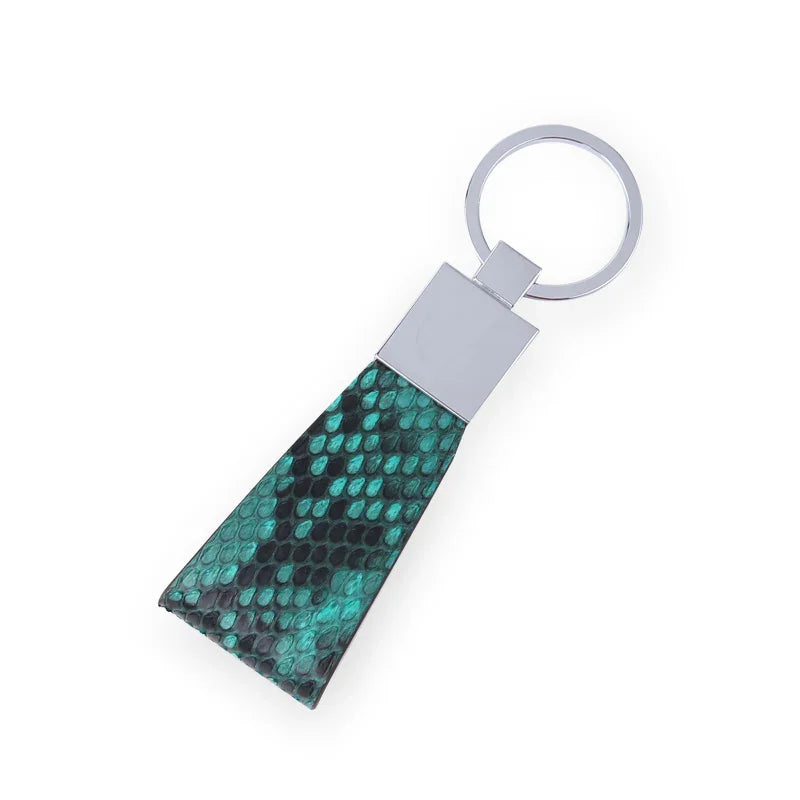 Green python skin keychain with silver clasp on a light gray background