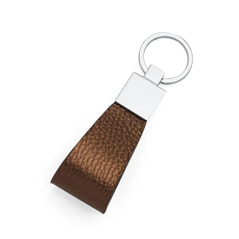 Trim Bronzo leather keychain with silver metal tag on a white background
