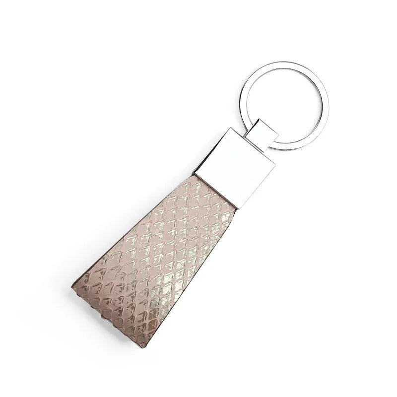 Metallic keychain with pink python skin on a white background