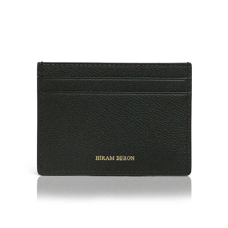 Black leather cardholder with 'Hiram Beron' branding on a white background