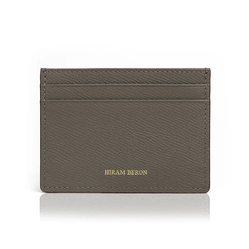 Gray cardholder with 'Hiram Beron' branding on a white background