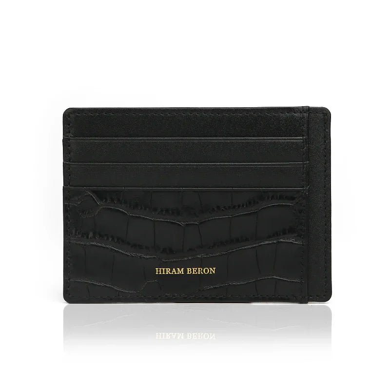 Front view of black embossed crocodile pattern leather card holder with 4 card slots