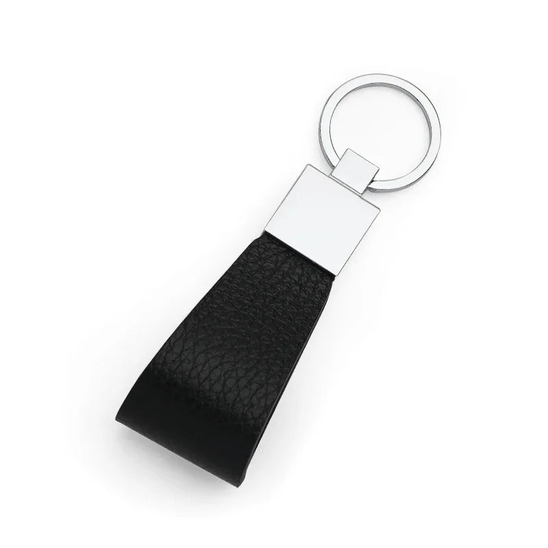 Black pebble leather keychain with silver ring on a white background