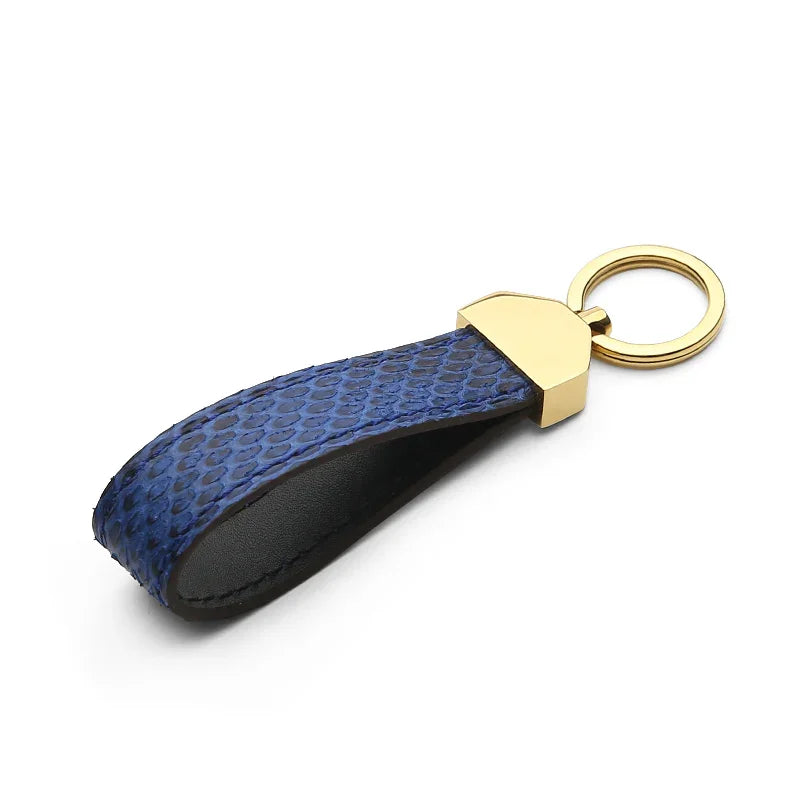 Blue python skin keychain with gold accent on a white background