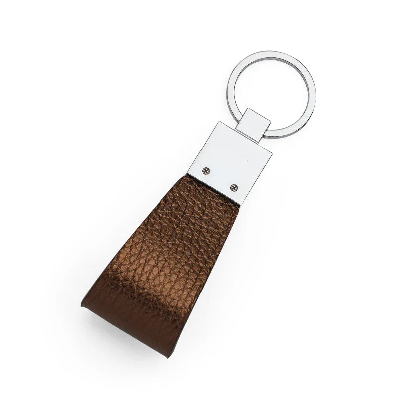 the back of trim bronzo pebble leather keychain with silver metal ring on a white background