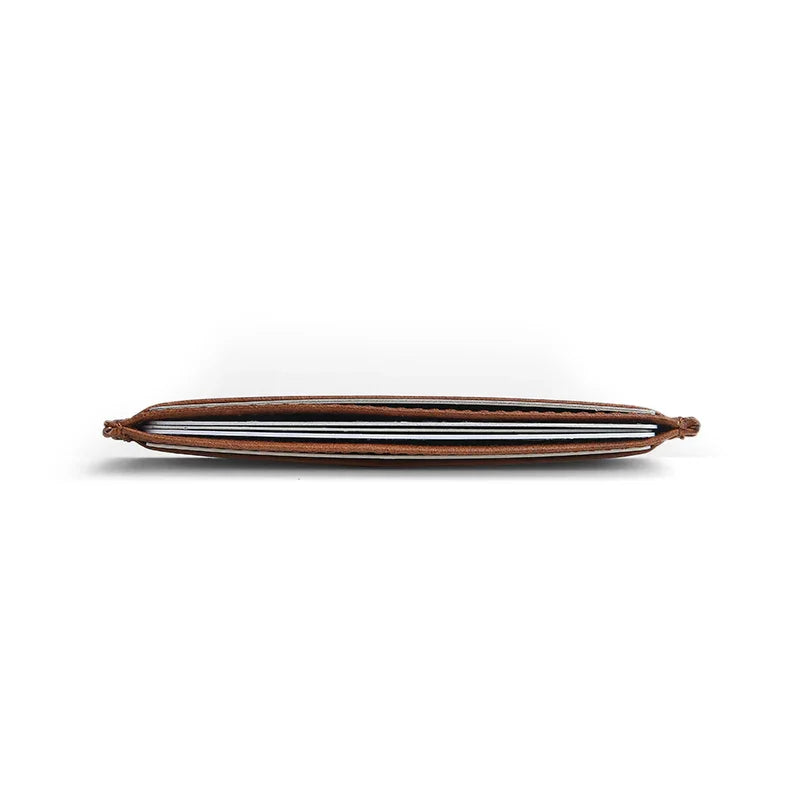 Thin brown leather card holder on a white background