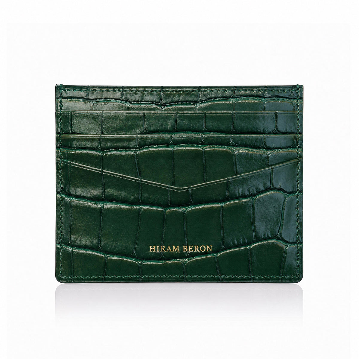 Green crocodile-patterned cardholder with 'Hiram Beron' branding on a white background