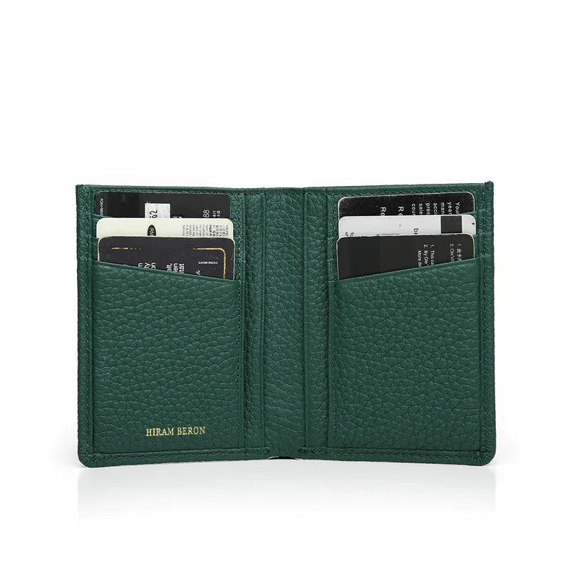 Green pebble leather wallet with card slots on a white background