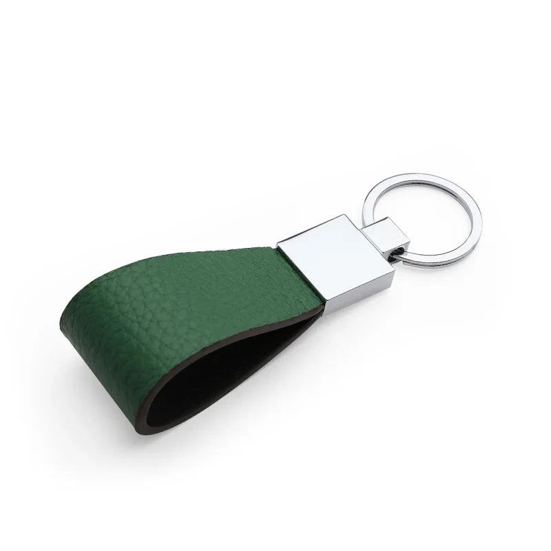 Green leather keychain with silver keyring on a white background