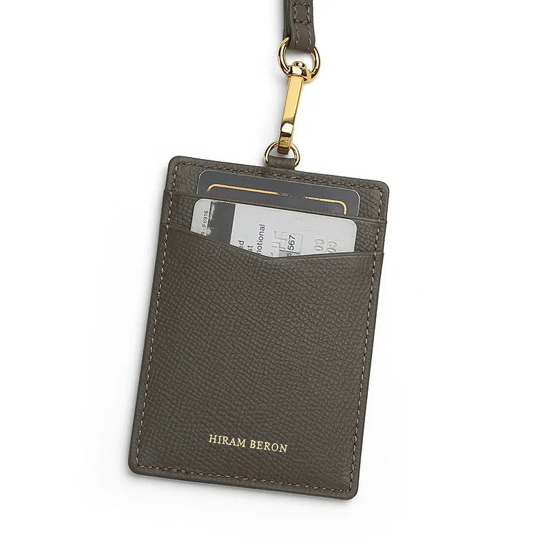 Gray leather card holder with a lanyard on a white background
