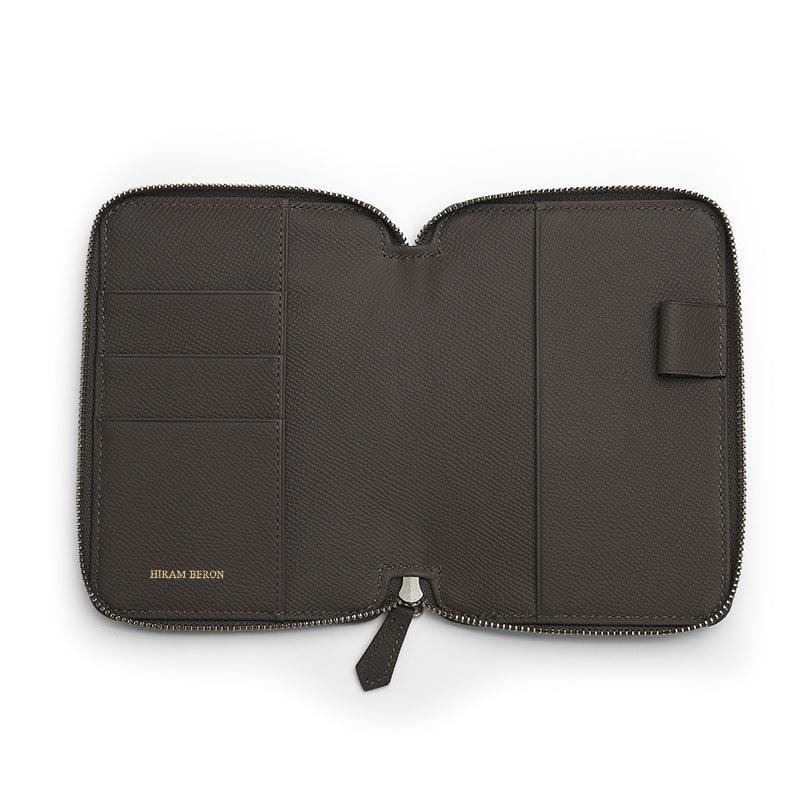Grey leather passport wallet with zipper on a white background