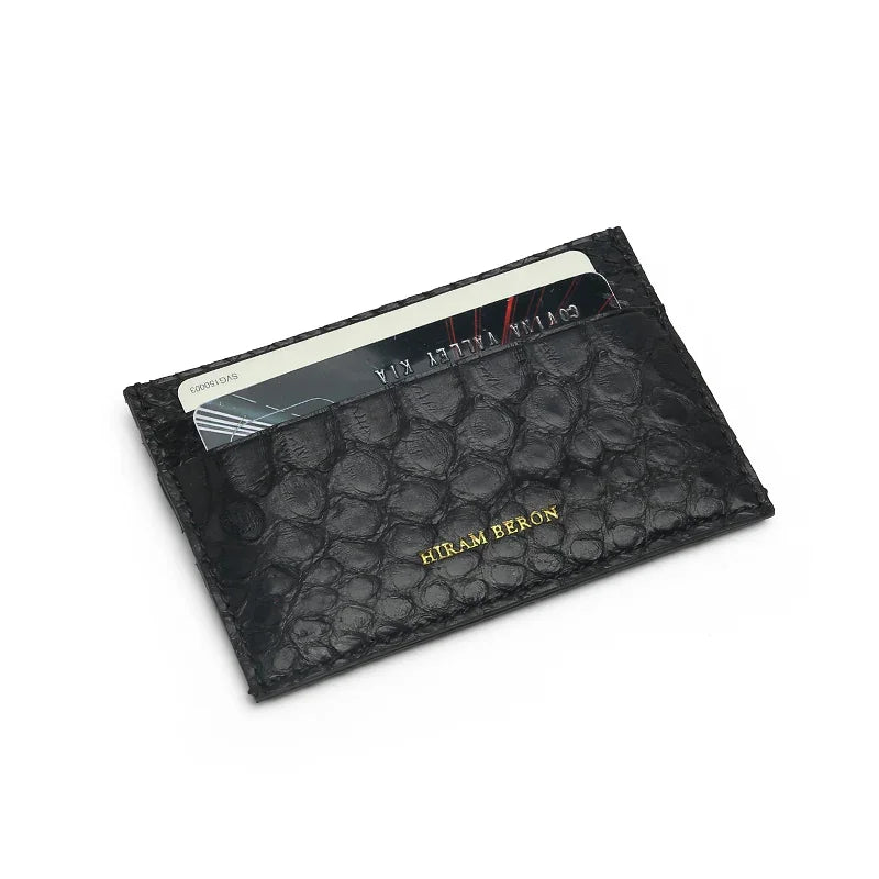 Black real python skin card holder with 'Hiram Beron' branding on a white background