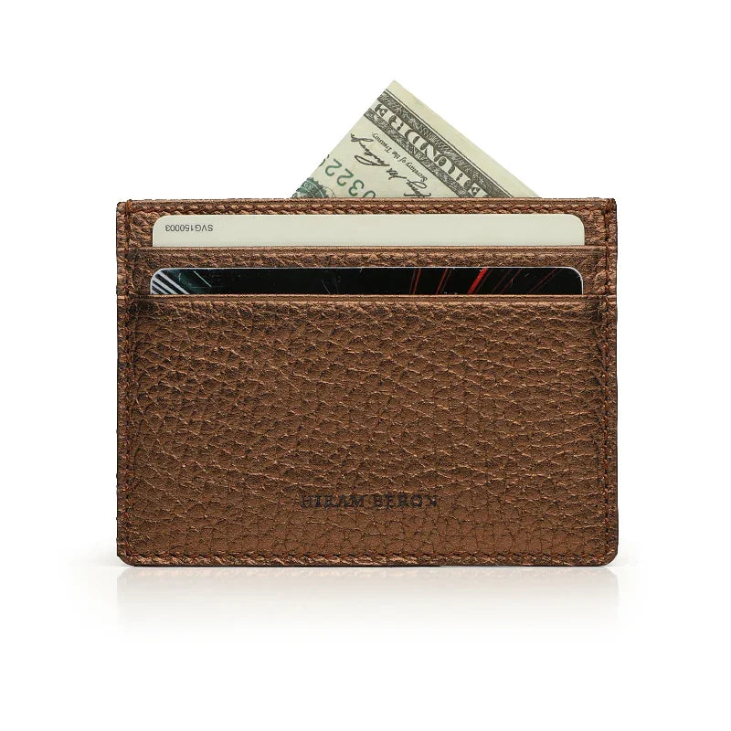 Trim Bronzo pebble leather card holder with cards and money on a white background