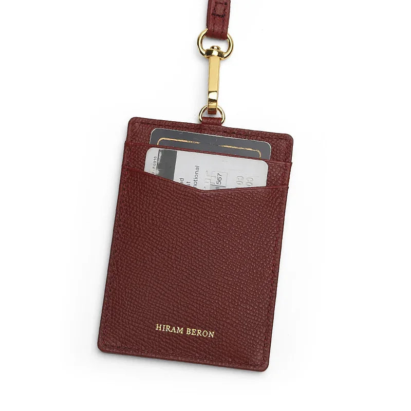 burgundy leather work badge holder with gold accent on a white background