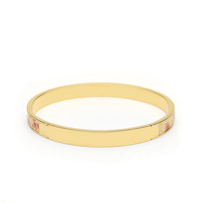 Gold bangle bracelet with floral enamel accents, elegant women's jewelry