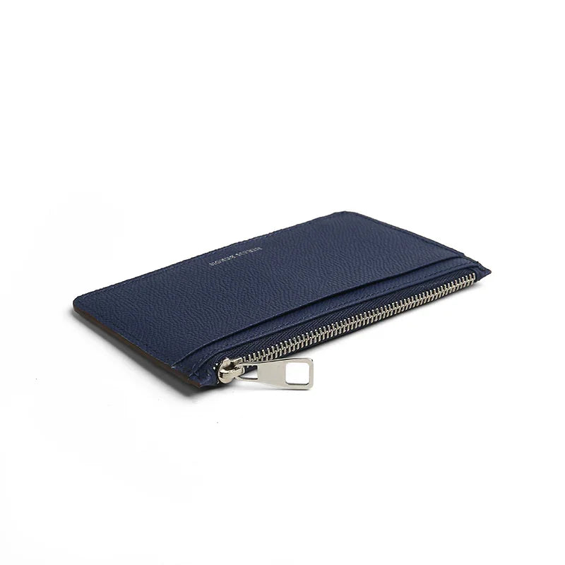 the close-up of the zipper puller for navy blue leather card case