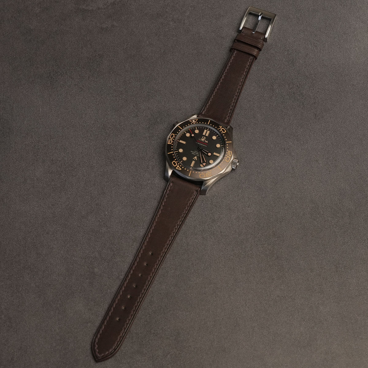 Complete dark brown French Haas Barenia watch strap mounted on luxury titanium vintage dive watch