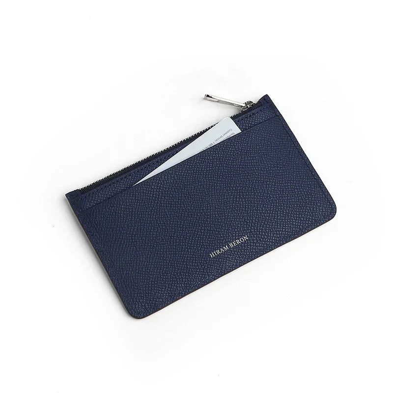 Navy blue zipper card case with a brand name "HIRAM BERON"on a white background