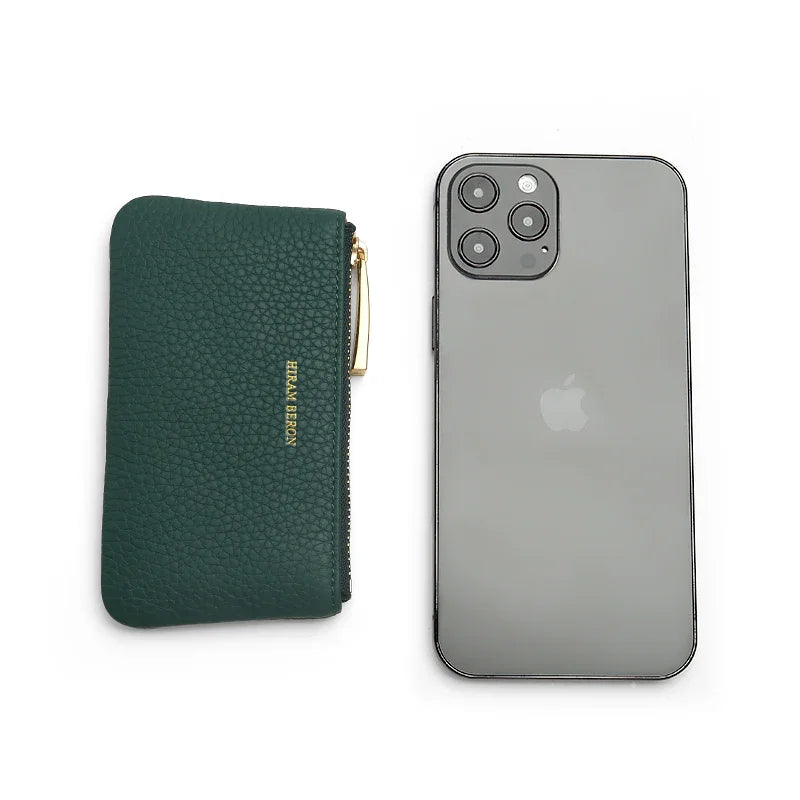 Green key case next to a gray smartphone on a white background
