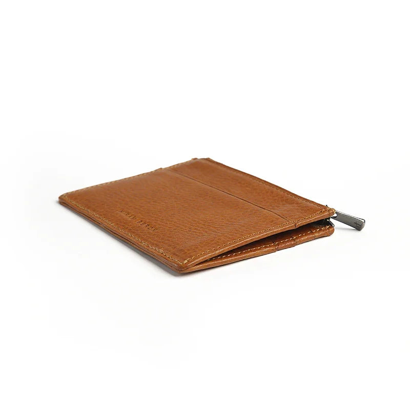 the detail of the right edge of the brown zipper wallet with a white background