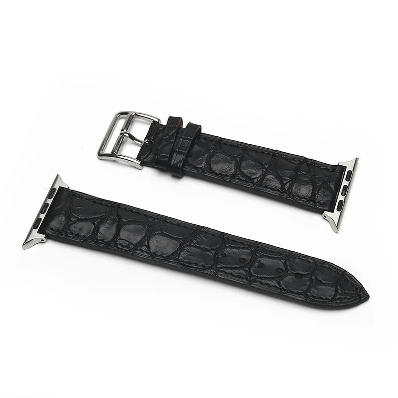 Black genuine aligator leather watch strap with silver buckle on a white background