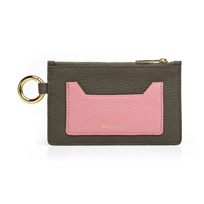 etoupe and pink wallet with gold ring on a white background