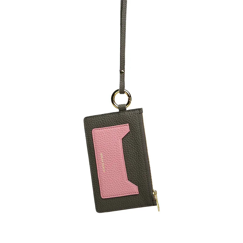Small card case with pink accent and gold zipper on a white background