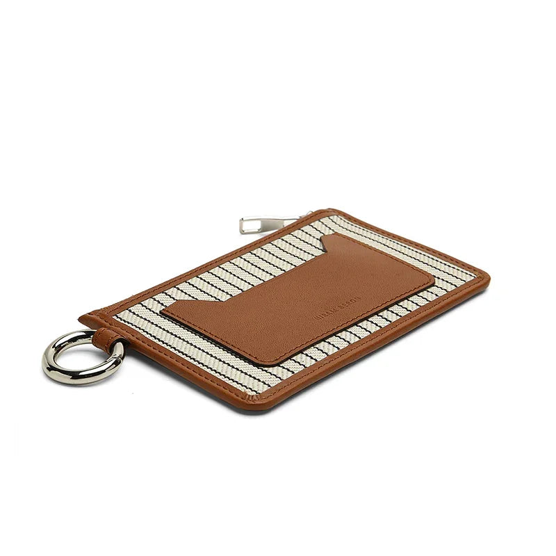 Brown leather keychain with striped pouch on a white background