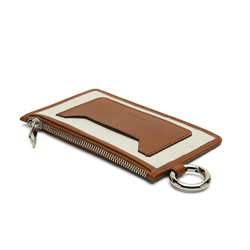 Brown leather and beige canvas wallet with zipper and key ring on a white background