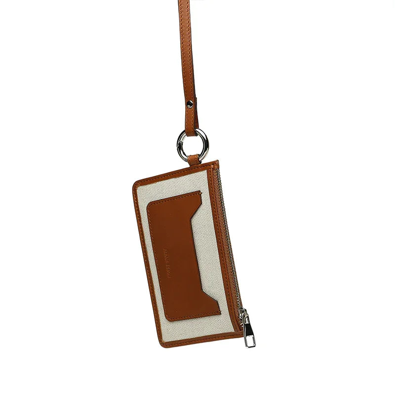Brown and plain beige card case with a strap on a white background