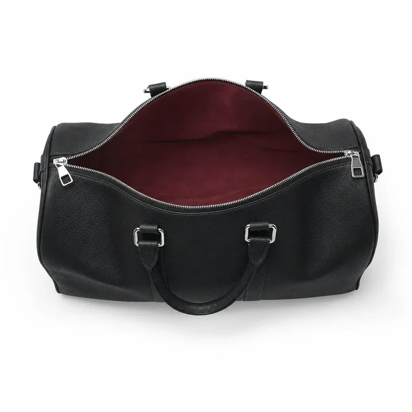 Black leather duffel bag with a red interior on a white background