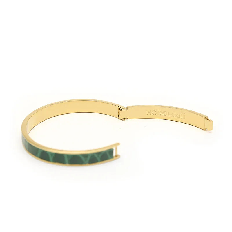 Gold bangle with green geometric pattern, sleek modern design for luxury accessories