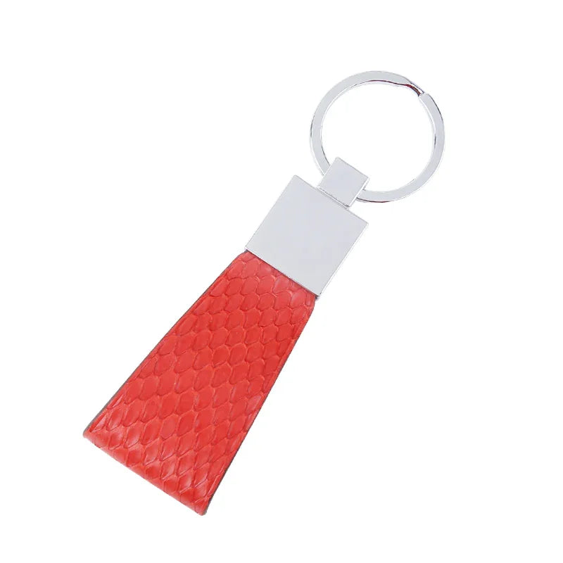 Red snake skin keychain with a silver ring on a white background