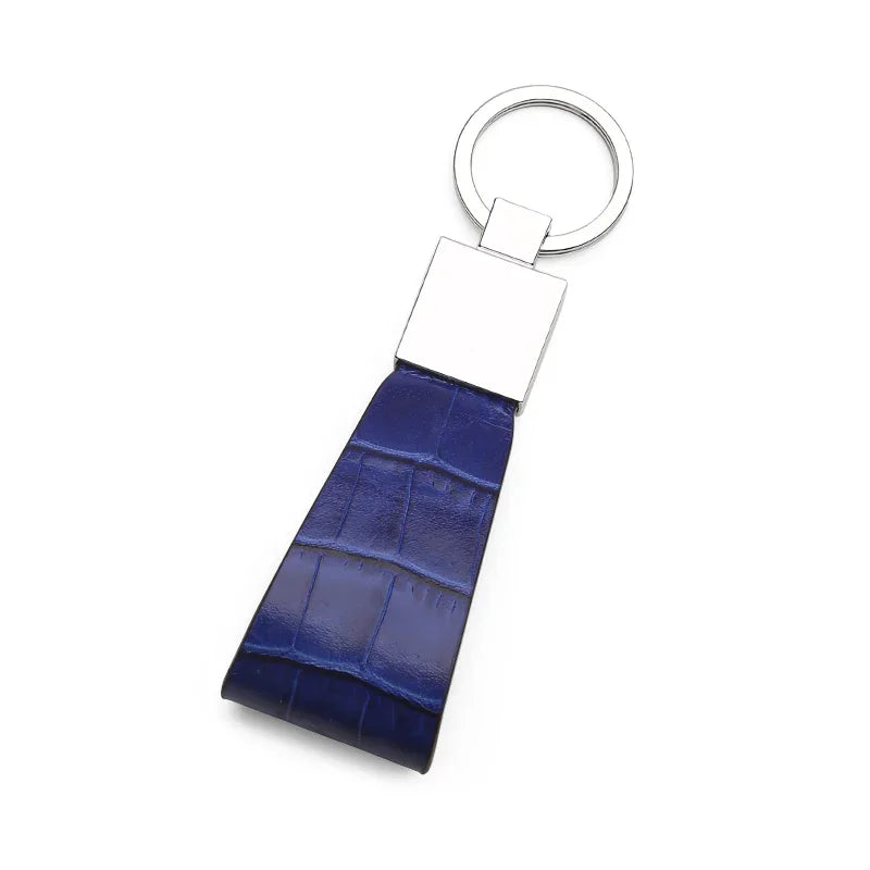 Blue crocodile-patterned keychain with a silver ring on a white background