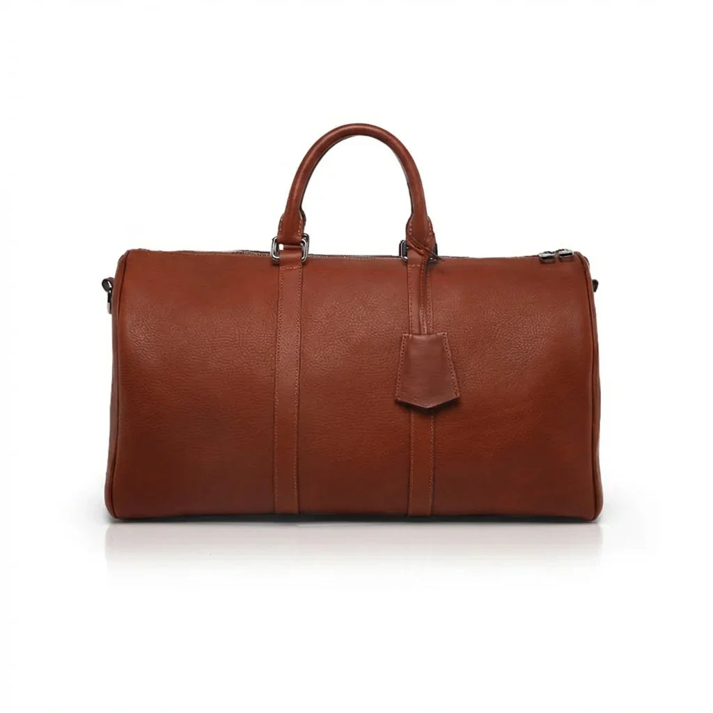 Brown leather weekender bag on a white background