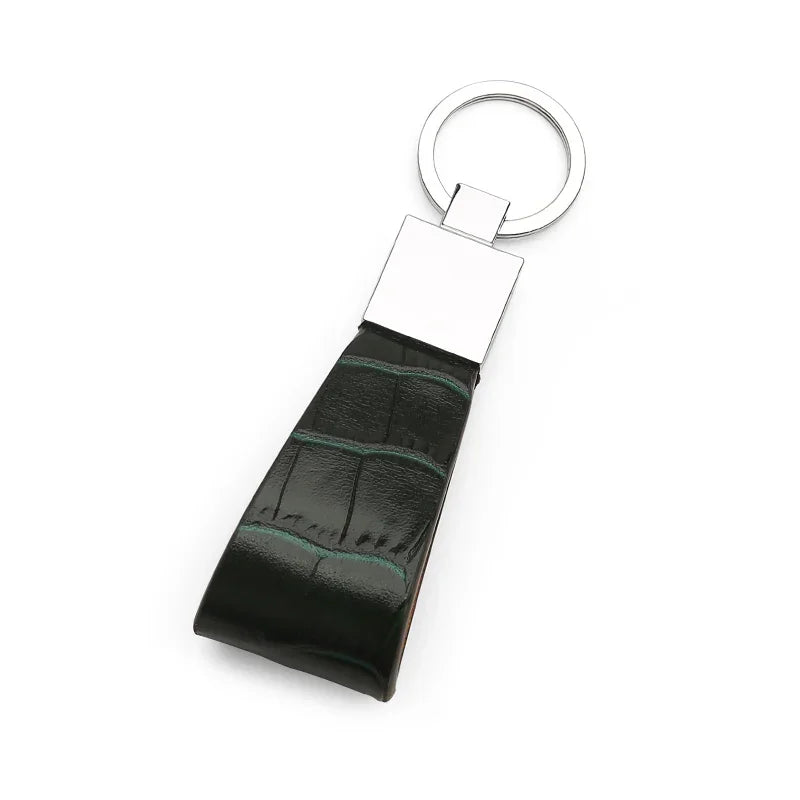 green leather keychain with a metallic ring on a white background