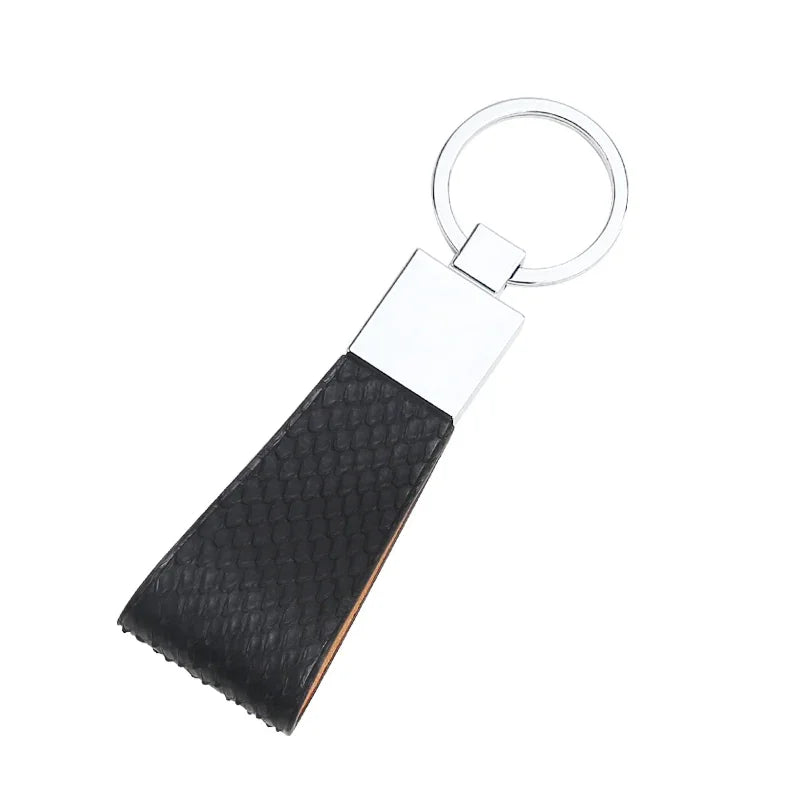 Black python skin keychain on a white background